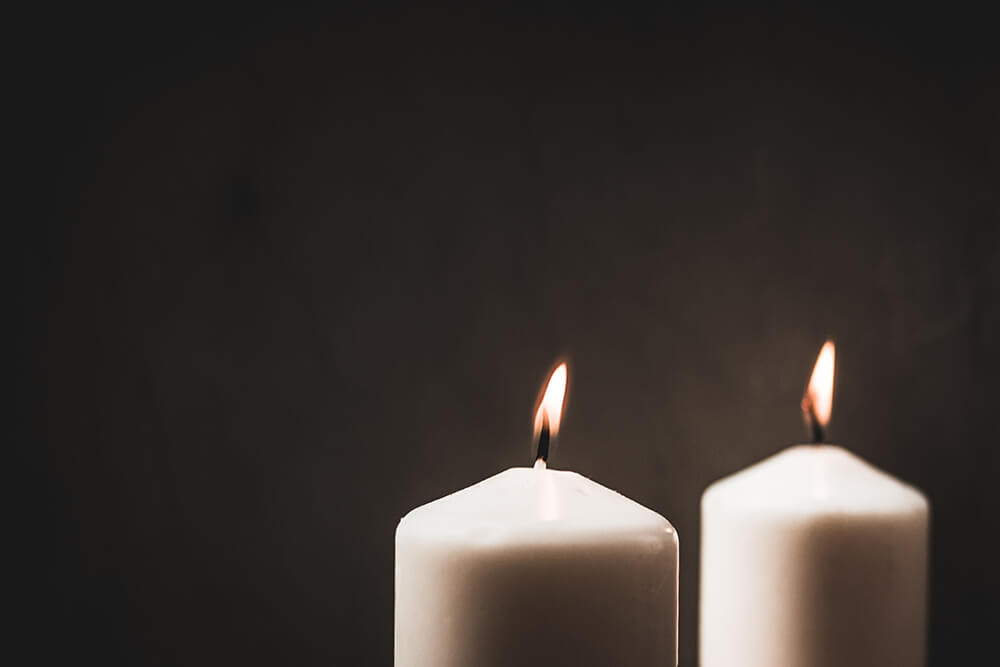 Two lit white candles